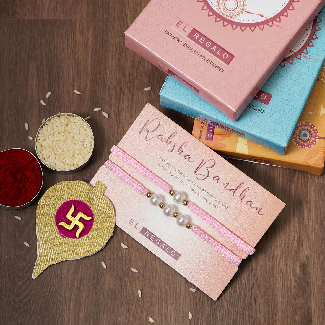 El Regalo 2PCs Pearls Rakhi Combo Set for Bhaiya-Bhabhi/Bhai- Bhatija/Bhatiji- Rakhi Gift Combo with 2 Pearls Rakhi, Roli-Chawal Shagun Pack, Message Card in Gift Box (Pink)