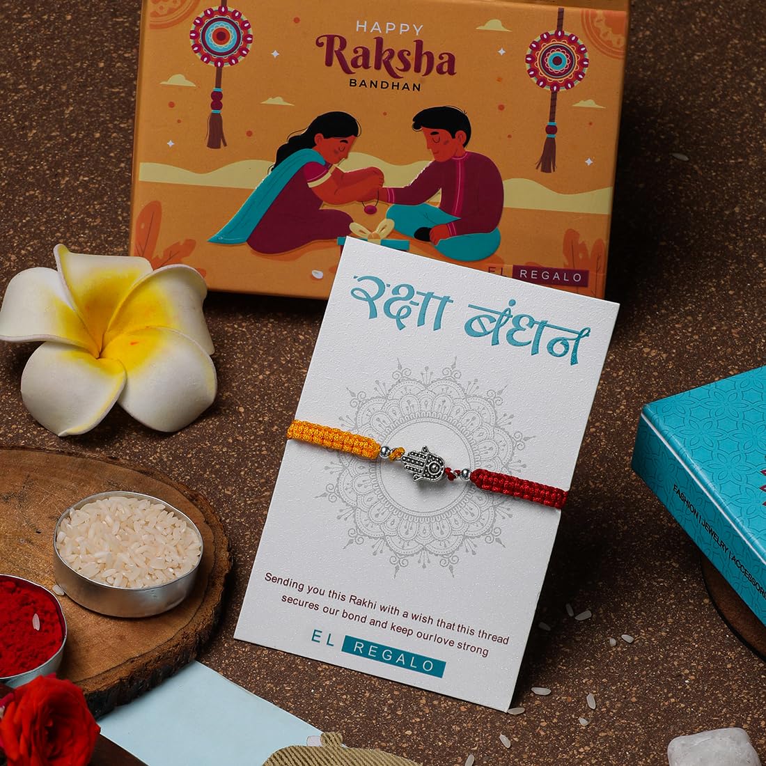 El Regalo 1 PC Designer Tassel Moli Rakhi, Hamsa Hand Moli Rakhi for Bhaiya - Rakshabandhan Red & Yellow Thread Rakhi with Message Card & Roli Chawal Shagun in Rakhi Box