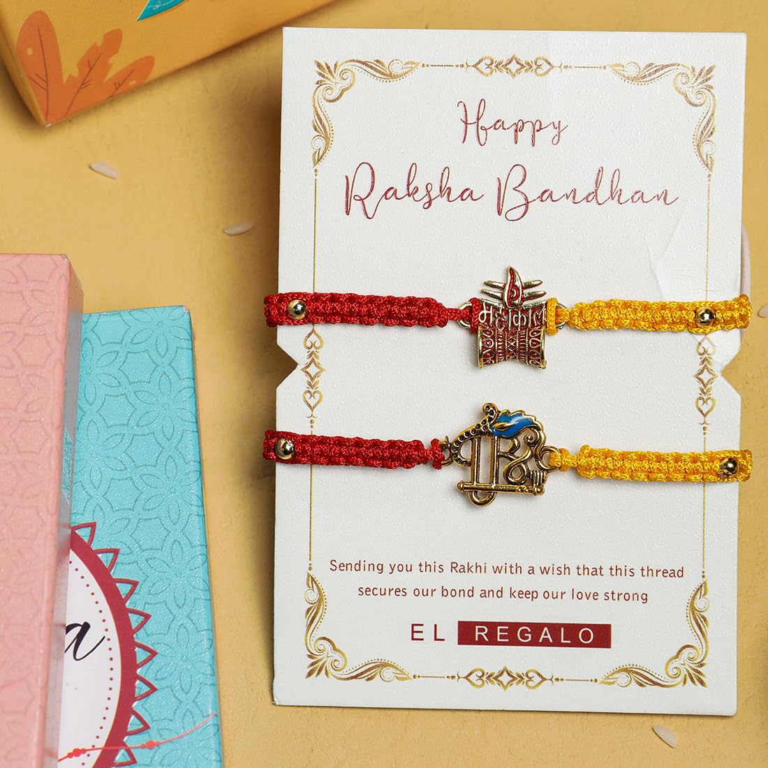 El Regalo 1PC Auspicious Thread Rakhi Brother- Red & Yellow Thread OM, Ganesha, Shree, Trident, Damroo Mauli Rakhi with Roli Chawal Shagun, Message Card in Rakhi Gift Box (Shree Rakhi)