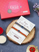 El Regalo 2PCs Simple Evil Eye Silver & Golden Beads Bracelet Rakhi Set for Brothers/Bhaiya-Bhabhi with Roli Chawal In Rakhi Gift Box- Elegant Rakhi for Bhai (Red & Blue Golden)