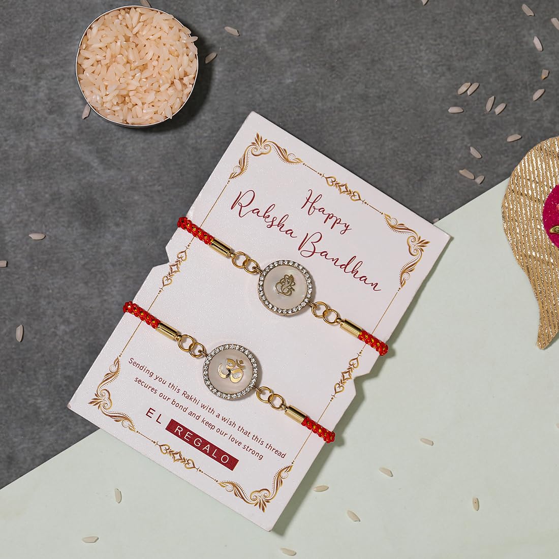 El Regalo 2PCs Designer OM & Ganesha Zircon Red Bracelet Rakhis for Brother/Bhabhi- Auspicious OM & Ganesha Rakhi Combo - Comes with Message Card, Roli-Chawal & Rakhi Box