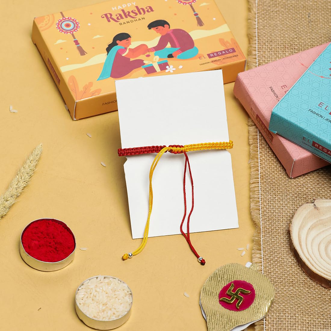 El Regalo 1PC Designer Evil Eye Red & Yellow Mauli Thread Rakhi for Brother - Rakshabandhan CZ Evil Eye Rakhi with Message Card & Roli Chawal in Rakhi Box for Bhaiya/Babhi/Bhatija/Bhatiji