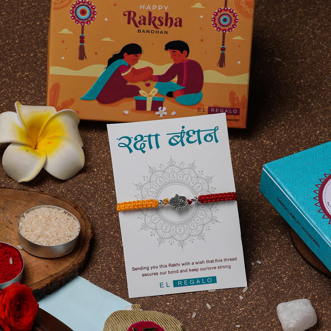 El Regalo 1 PC Designer Tassel Moli Rakhi, Hamsa Hand Moli Rakhi for Bhaiya - Rakshabandhan Red & Yellow Thread Rakhi with Message Card & Roli Chawal Shagun in Rakhi Box
