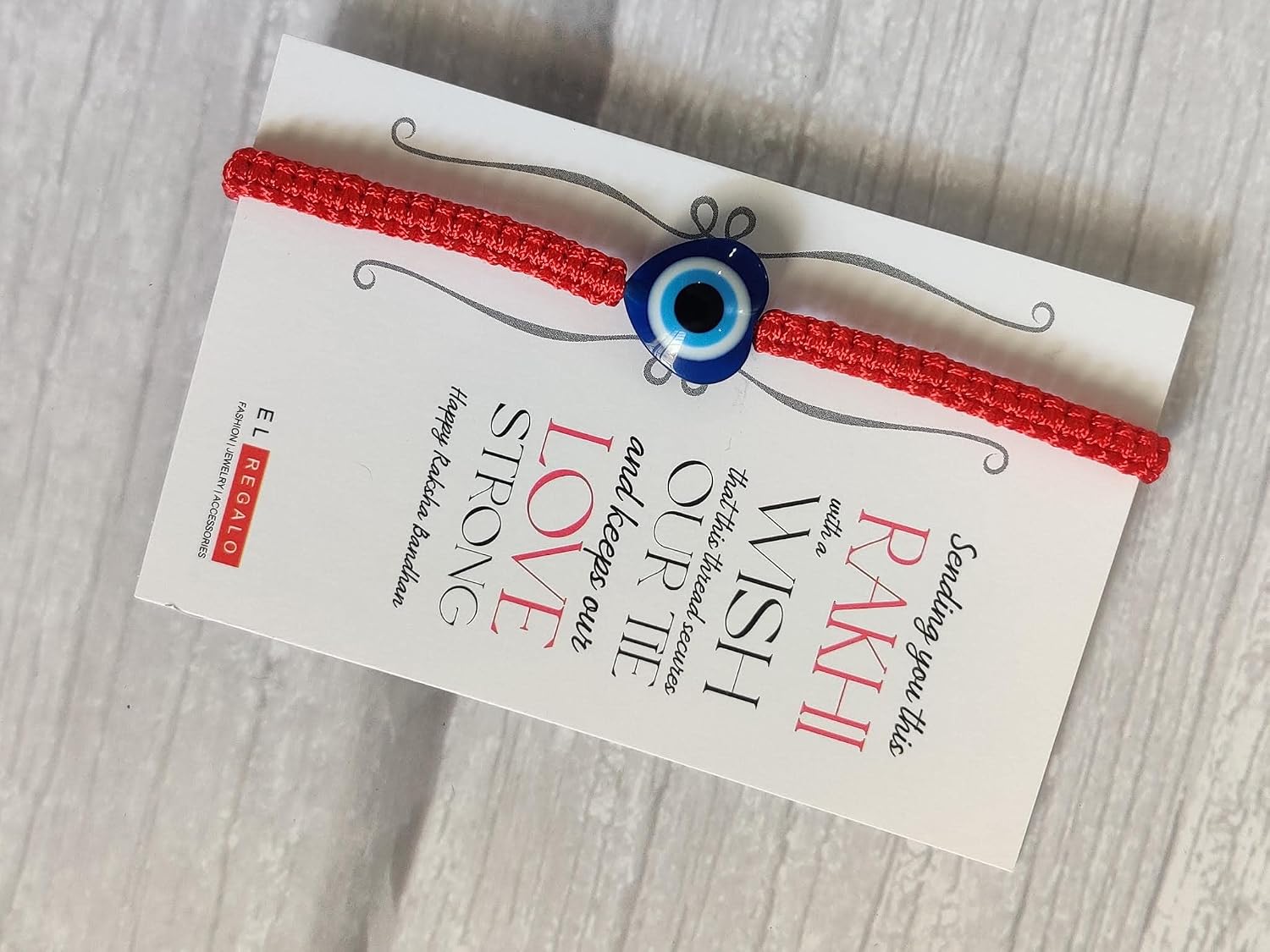 El Regalo 1 Evil Eye Rakhi with and Raksha Bandhan Card - Lucky Evil Eye Protection Rakhi to Avoid Negative Energies for Brother/Sister-in-Law/Niece or Nephew (Heart Evil Eye)